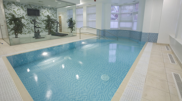 Our pool designer recommended a separated gym to ensure the pool room temperatures did not make the daily work out too unpleasant.